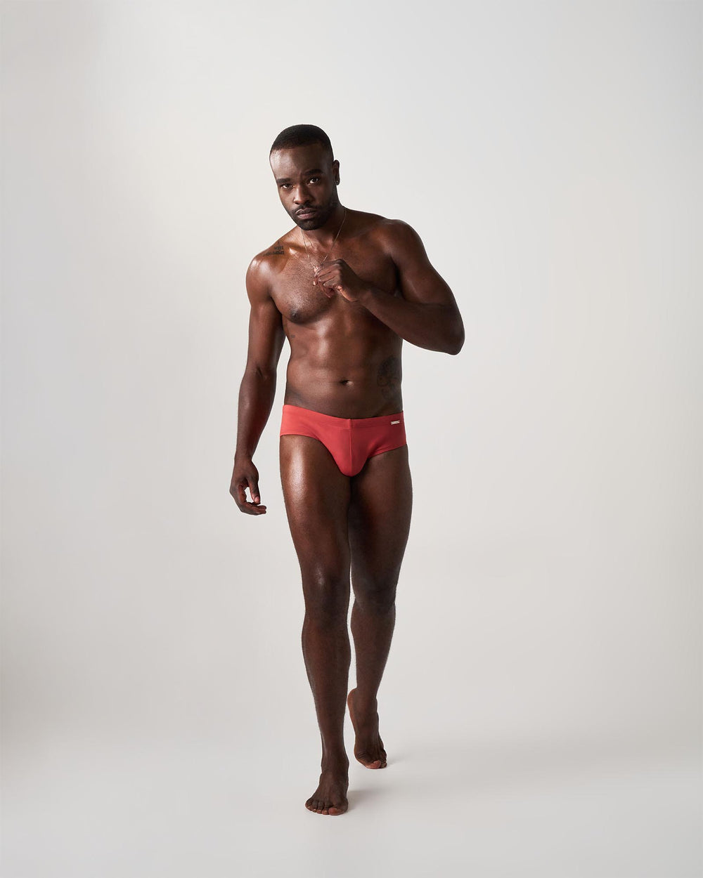 Man wearing red swim brief on a white background